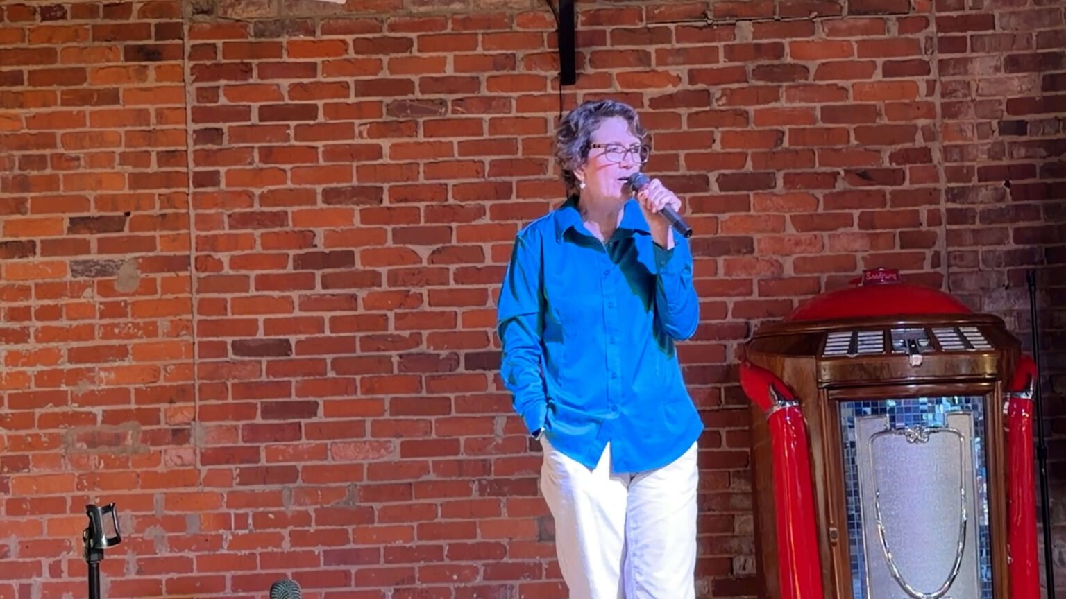 Sandy Vecchi delivering a keynote on stage